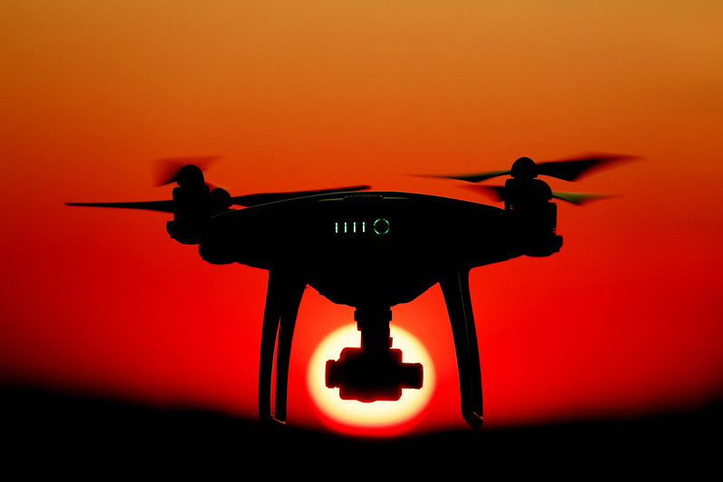 Drone facing sun at sunset, orange sky (cc Marco Verch)